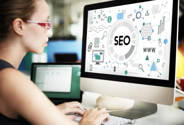 Woman working on SEO and Marketing at computer