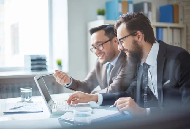 business men viewing web design on laptop